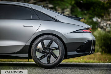 Hyundai Ioniq 6 – rear three-quarter, matte grey against a mountain backdrop