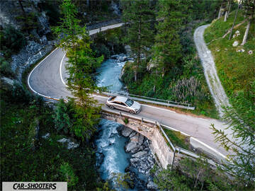 Hyundai Ioniq 6 – side profile, silver on a mountain bridge
