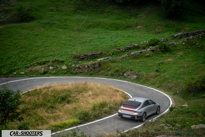 Hyundai Ioniq 6 – rear three-quarter, silver on a winding country road