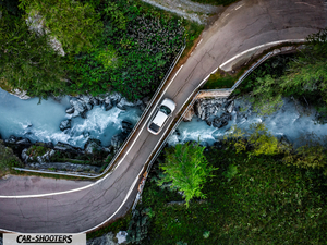 Hyundai Ioniq 6 – side profile, white on a bridge over a river