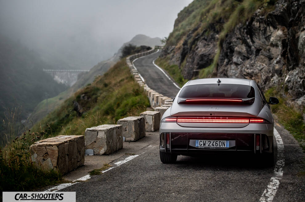 Hyundai Ioniq 6 – rear view, silver on a winding mountain road