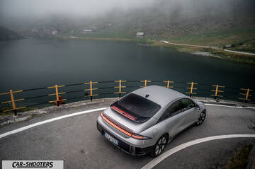 Hyundai Ioniq 6 – rear three-quarter, silver on a winding mountain road