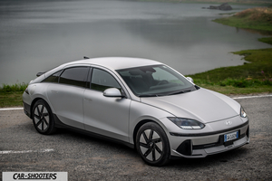 Hyundai Ioniq 6 – front three-quarter, silver on a road by water