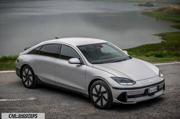 Hyundai Ioniq 6 – front three-quarter, silver on a road by water