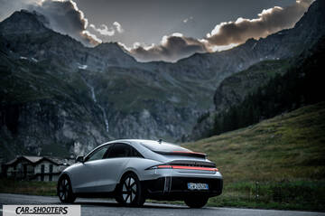 Hyundai Ioniq 6 – rear three-quarter, silver against a mountain backdrop