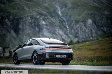 Hyundai Ioniq 6 – rear three-quarter, silver against a mountain backdrop