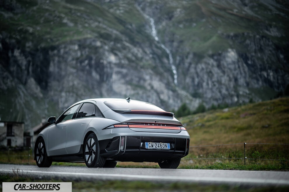 Hyundai Ioniq 6 – rear three-quarter, silver against a mountain backdrop