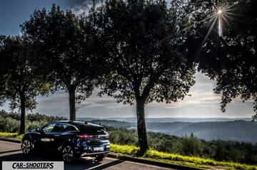 Renault Megane E TECH – rear three-quarter, black on a country road