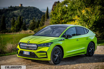Skoda Enyaq – front three-quarter, green on a dirt road