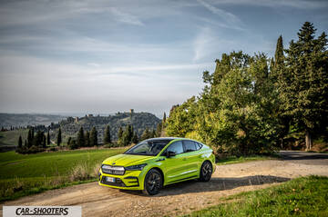 Skoda Enyaq – front three-quarter, lime green on a country road