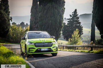 Skoda Enyaq – front three-quarter, green on a winding road