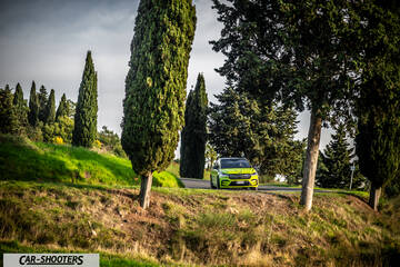 Skoda Enyaq – front three-quarter, yellow on a country road