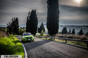 Skoda Enyaq – front three-quarter, lime green on a country road