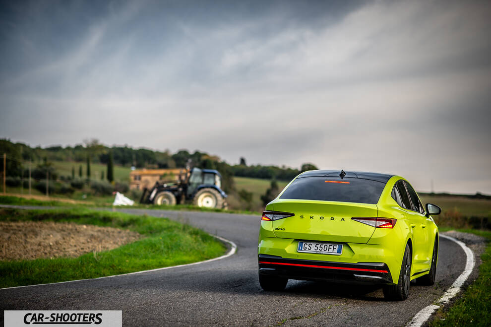 Skoda Enyaq – rear three-quarter, yellow-green on a country road