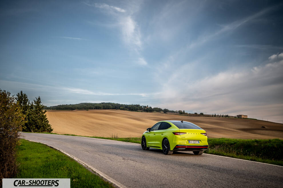 Skoda Enyaq – rear three-quarter, yellow on a country road