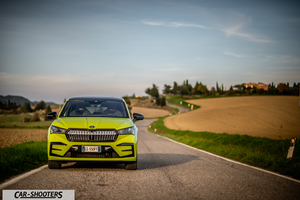 Skoda Enyaq – front three-quarter, yellow-green on a country road