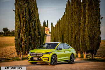 Skoda Enyaq – front three-quarter, yellow-green on a country road