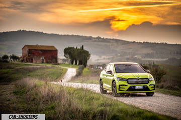 Skoda Enyaq – front three-quarter, bright green on a country road