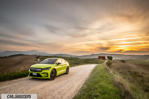 Skoda Enyaq – front three-quarter, yellow-green on a country road