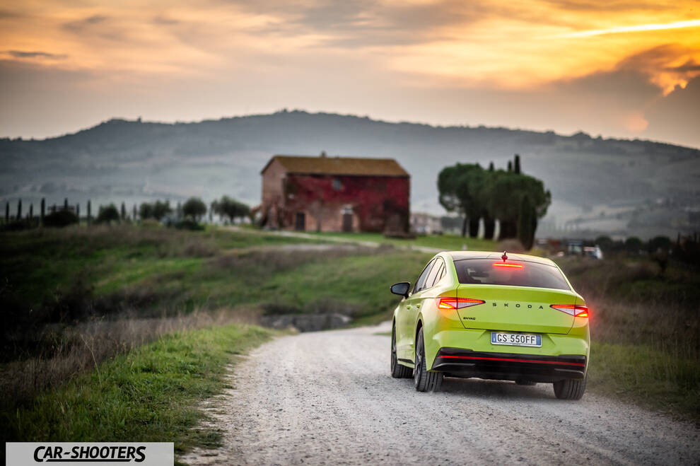 Skoda Enyaq – rear three-quarter, lime green on a country road