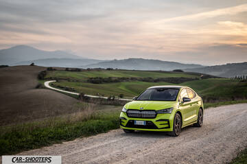 Skoda Enyaq – front three-quarter, yellow against a mountain backdrop
