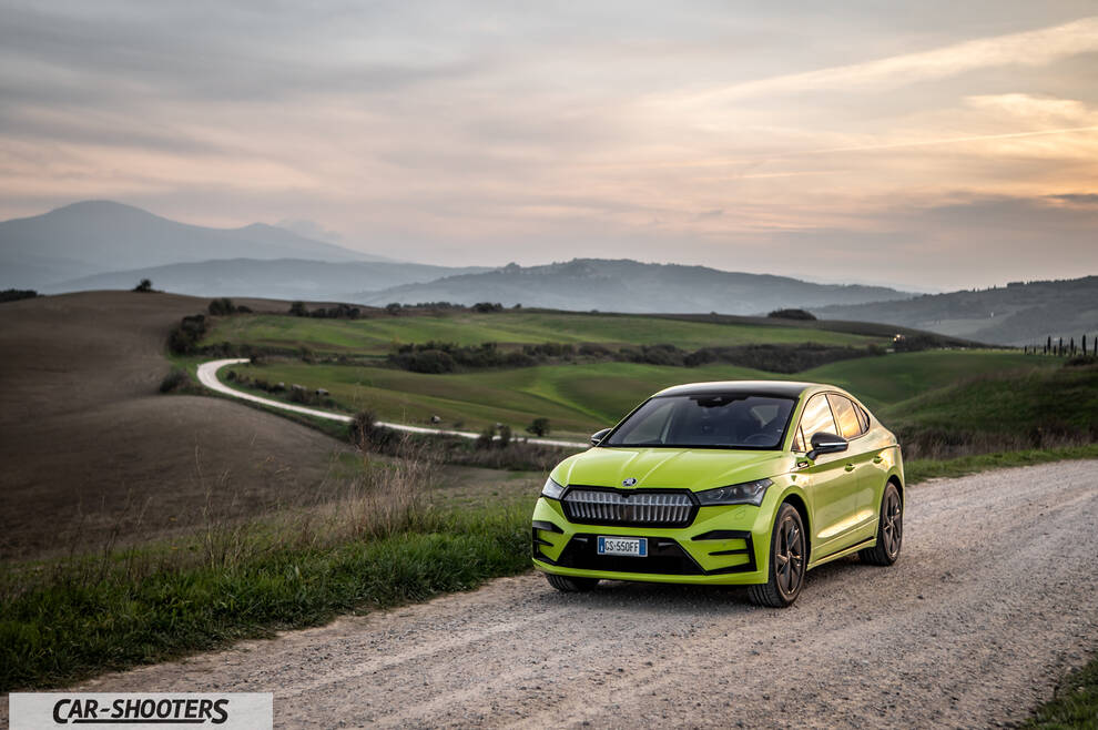 Skoda Enyaq – front three-quarter, yellow against a mountain backdrop