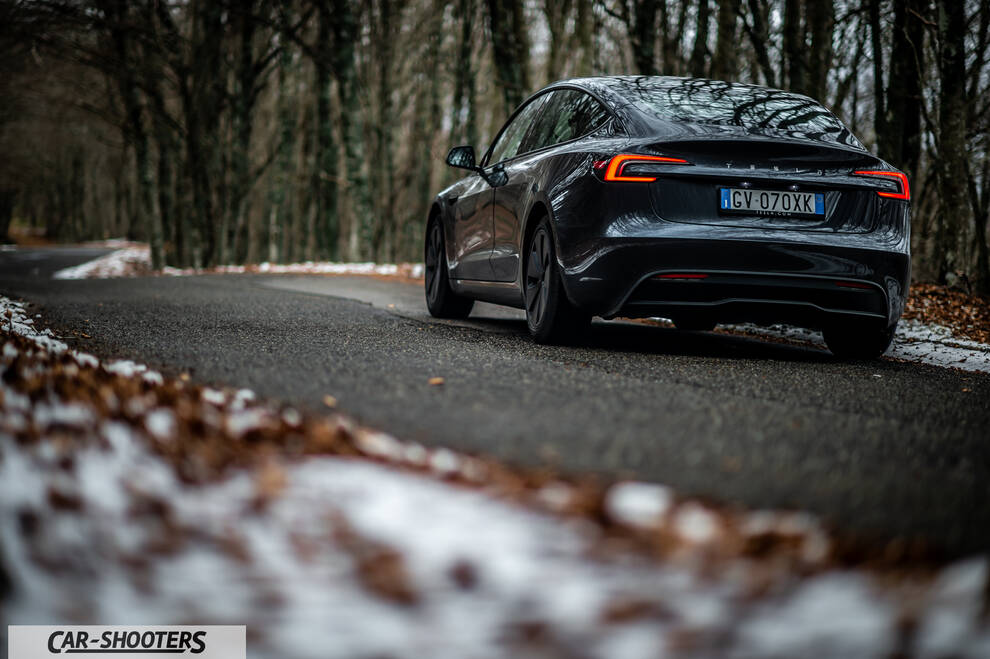Tesla Model 3 2025 – rear three-quarter, dark grey on a snowy country road