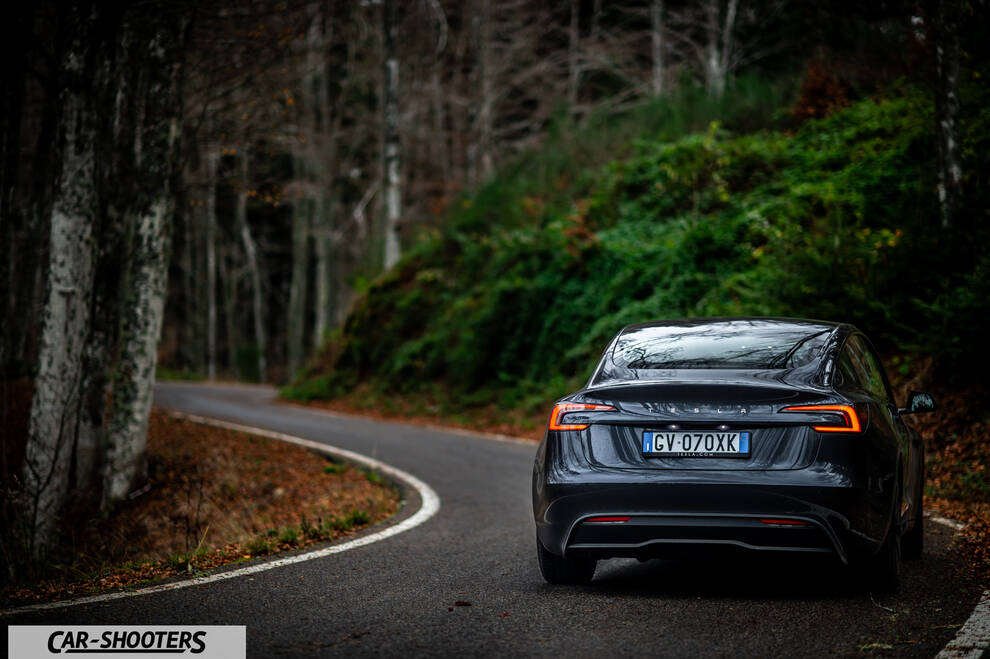 Tesla Model 3 2025 – rear view, dark grey on a country road