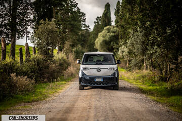Volkswagen ID BUZZ – front three-quarter, silver and blue on a country road