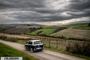 Volkswagen ID BUZZ – rear three-quarter, dark grey and silver on a country road