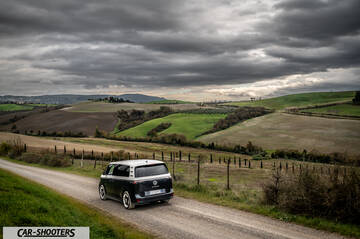 Volkswagen ID BUZZ – rear three-quarter, dark grey and silver on a country road