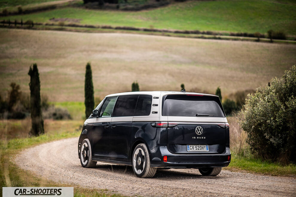 Volkswagen ID BUZZ – rear three-quarter, dark blue and silver on a country road