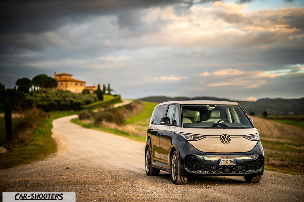 Volkswagen ID BUZZ – front three-quarter, beige and dark blue on a country road