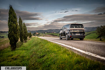 Volkswagen ID BUZZ – rear three-quarter, black on a country road