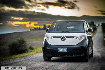 Volkswagen ID BUZZ – front three-quarter, white and black on a country road at sunset