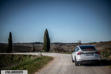 Tesla Model X – rear three-quarter, silver on a country road