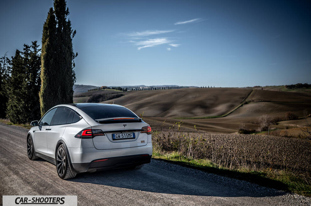 Tesla Model X – rear three-quarter, silver on a country road