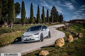 Tesla Model X – front three-quarter, silver on a country road
