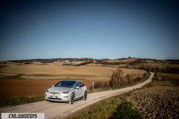Tesla Model X – front three-quarter, silver on a country road