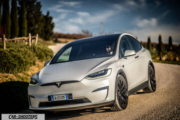 Tesla Model X – front three-quarter, silver on a country road