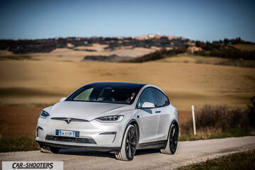 Tesla Model X – front three-quarter, silver on a country road