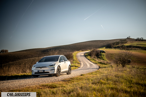 Tesla Model X – front three-quarter, white on a country road