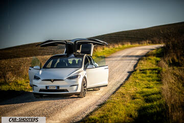 Tesla Model X – front three-quarter, white on a dirt road