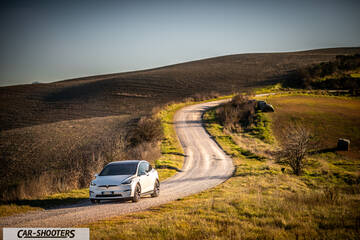 Tesla Model X – front three-quarter, white on a winding dirt road