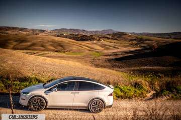 Tesla Model X – side profile, white against a mountain backdrop