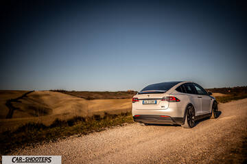 Tesla Model X – rear three-quarter, white on a country road