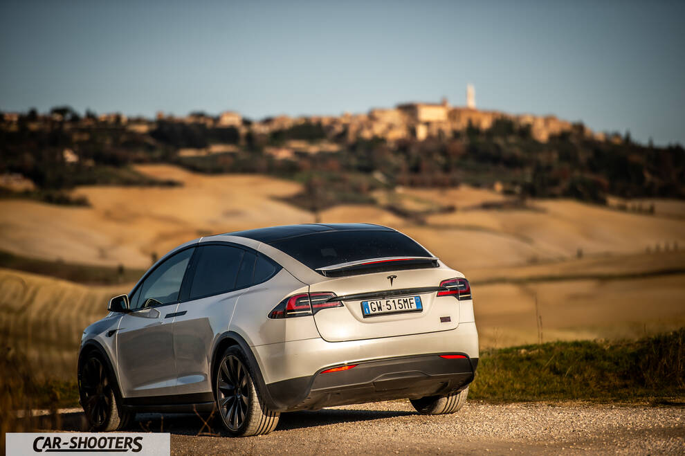 Tesla Model X – rear three-quarter, silver against a Tuscan hillside backdrop