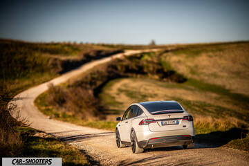 Tesla Model X – rear three-quarter, white on a country road