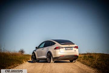 Tesla Model X – rear three-quarter, white on a country road