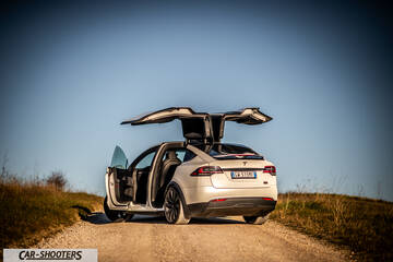 Tesla Model X – rear three-quarter, white on a country road
